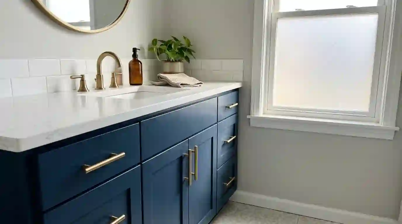 Bathroom vanity freshly painted deep navy with brass pulls
